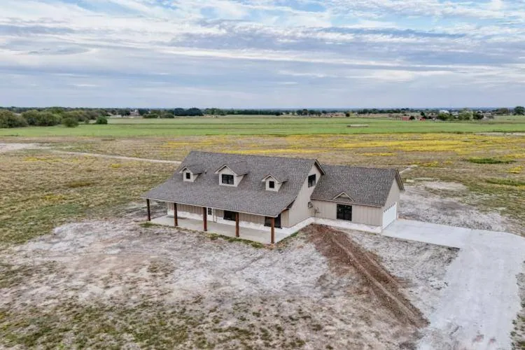 Aerial view of the front of the home and driveway