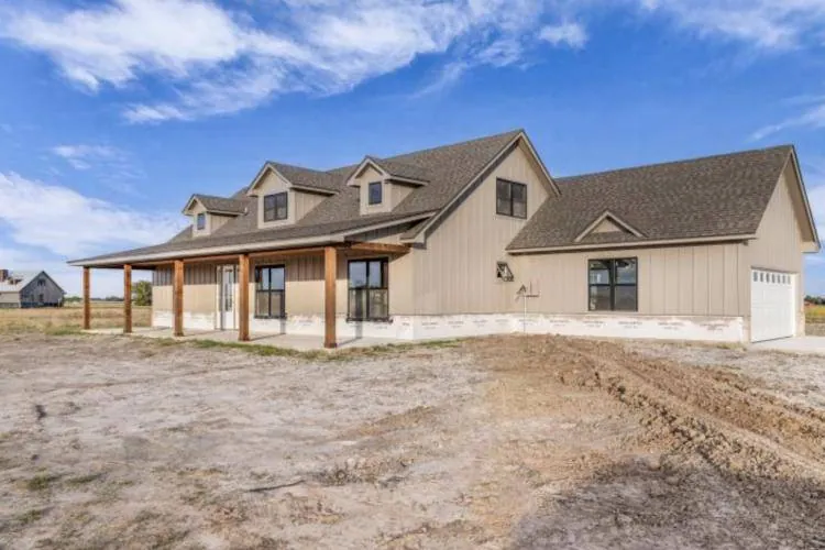 Front corner of the home showing dormers and the attached two-car garage