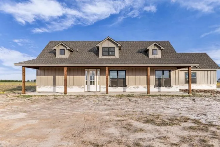 Front of 296 Sorghum Hill, a modern farmhouse with dormers and a long covered front porch