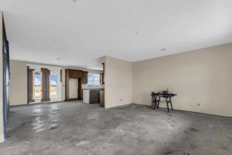 Open living room looking toward the dining area and French doors
